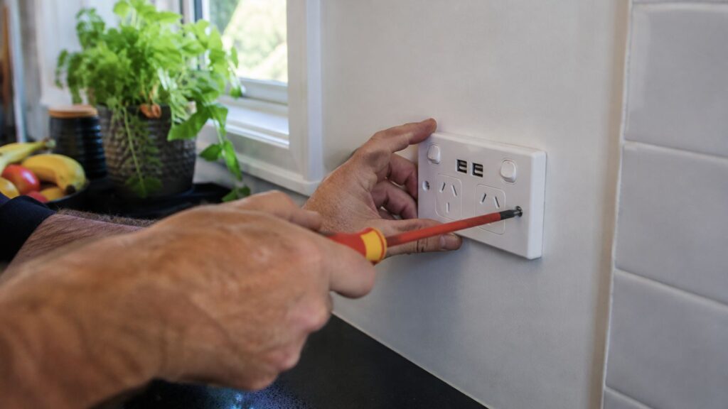 Electrician fitting a USB power point